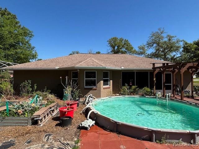 outdoor pool featuring a vegetable garden