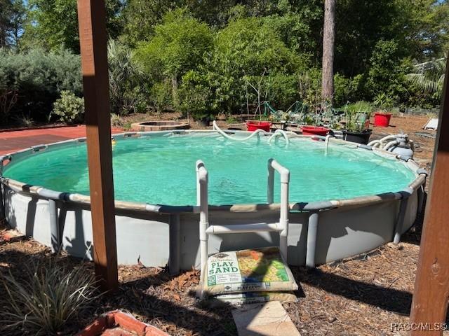 view of pool featuring a hot tub