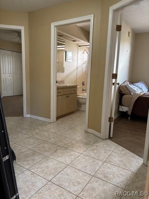 hall with light tile patterned floors and baseboards