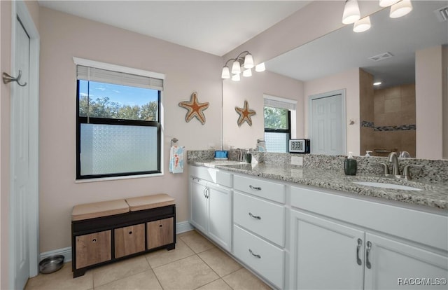 bathroom with vanity, a chandelier, and tile patterned flooring