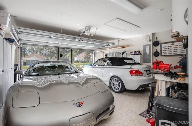 garage with a garage door opener and electric panel