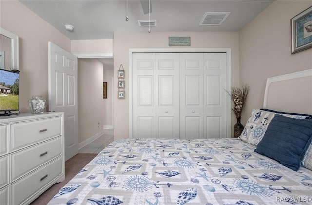 tiled bedroom featuring a closet