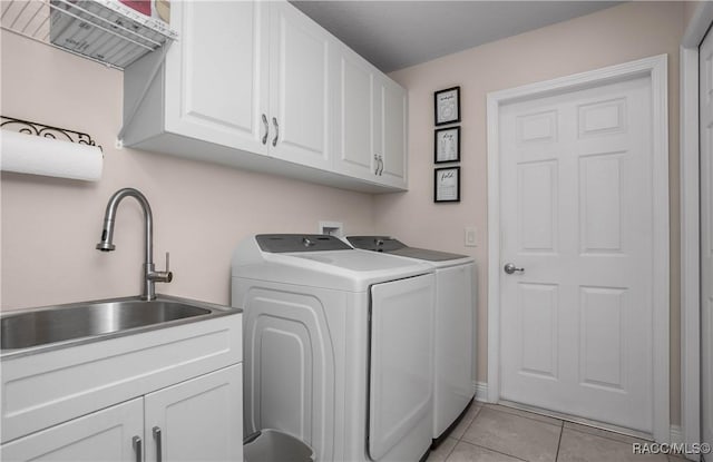 laundry room featuring cabinets, sink, independent washer and dryer, and light tile patterned flooring