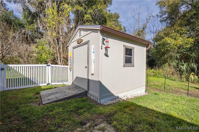 view of outbuilding with a lawn