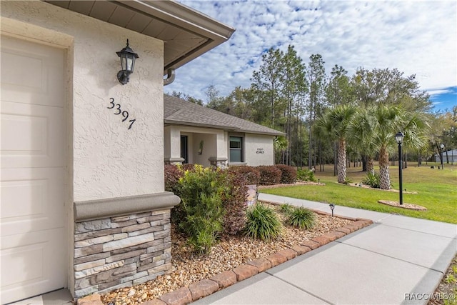 view of exterior entry with a yard