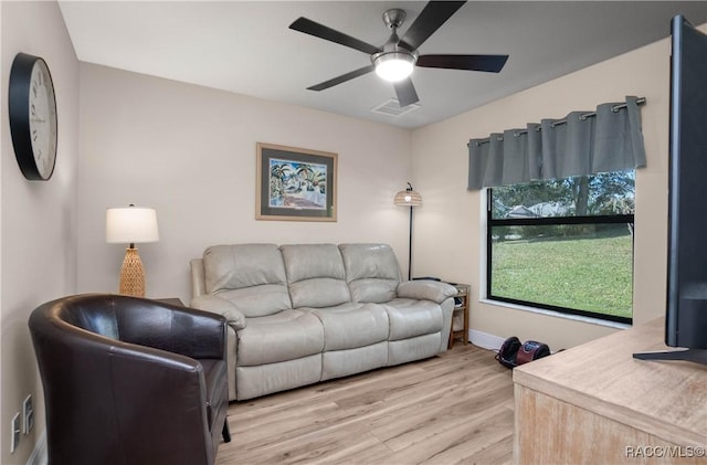 living room with lofted ceiling, ceiling fan, and light hardwood / wood-style flooring