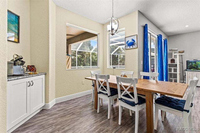 dining room with an inviting chandelier and dark wood-type flooring