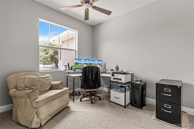 office area featuring carpet flooring, ceiling fan, and a healthy amount of sunlight