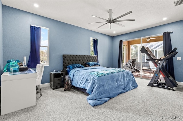 carpeted bedroom with a textured ceiling and ceiling fan