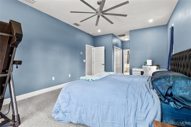 carpeted bedroom with ceiling fan and ensuite bathroom