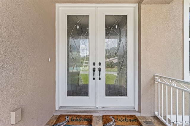 entrance to property featuring french doors