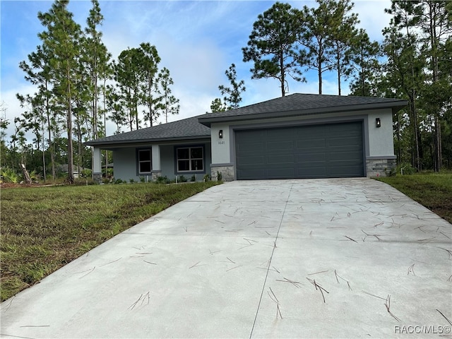 view of front of home featuring a garage and a front lawn