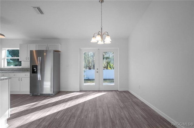 kitchen with dark hardwood / wood-style floors, white cabinets, stainless steel fridge, a chandelier, and hanging light fixtures