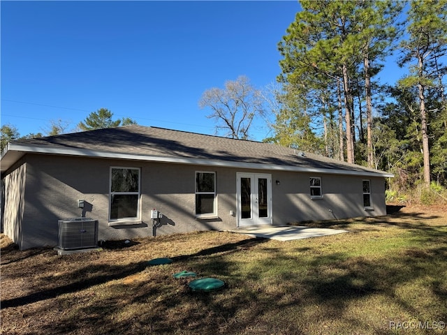 rear view of property featuring a lawn, a patio area, central air condition unit, and french doors