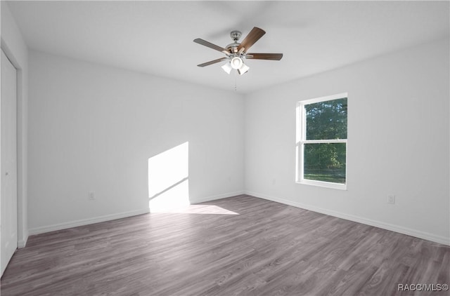 spare room with hardwood / wood-style flooring and ceiling fan