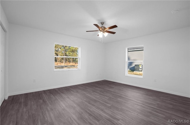 unfurnished room featuring ceiling fan and dark hardwood / wood-style flooring