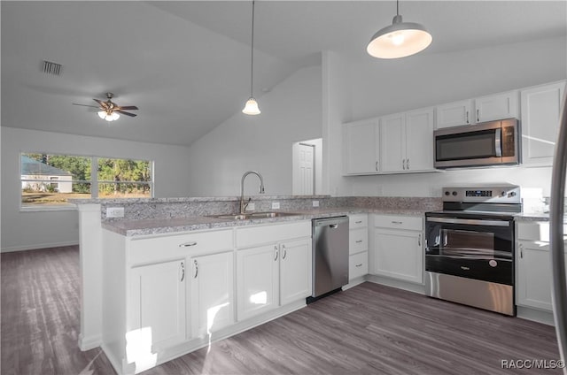 kitchen featuring stainless steel appliances, white cabinetry, sink, and pendant lighting