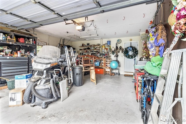 garage with a workshop area and a garage door opener