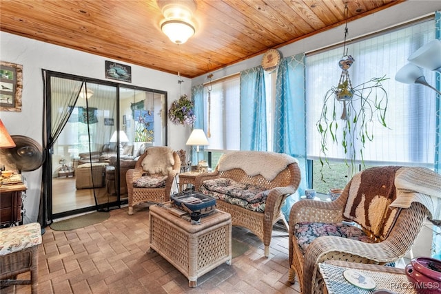 sunroom with a healthy amount of sunlight and wooden ceiling