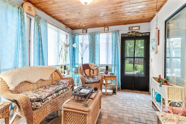 sunroom featuring a healthy amount of sunlight and wooden ceiling