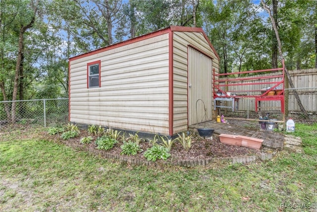 view of outbuilding featuring a lawn