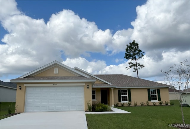 single story home with a garage and a front lawn