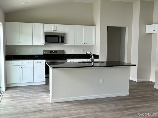 kitchen featuring white cabinets, appliances with stainless steel finishes, and a center island with sink