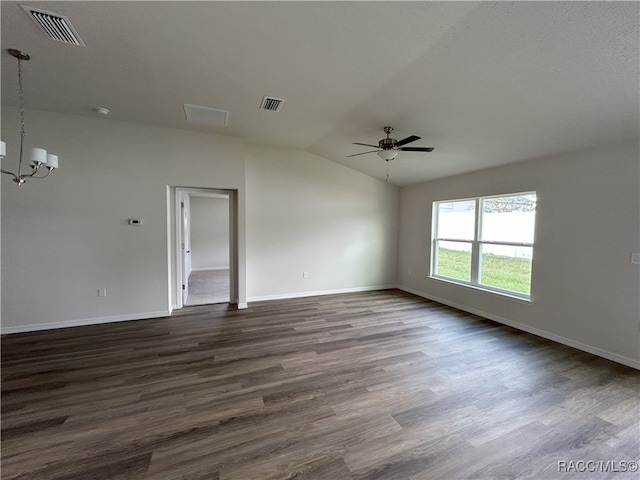 empty room with lofted ceiling, ceiling fan with notable chandelier, and dark hardwood / wood-style floors