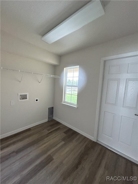 washroom featuring electric dryer hookup, dark wood-type flooring, washer hookup, and a textured ceiling