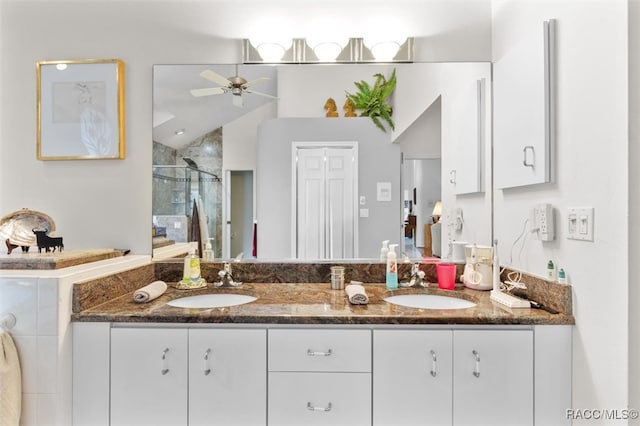 bathroom featuring ceiling fan, an enclosed shower, lofted ceiling, and vanity