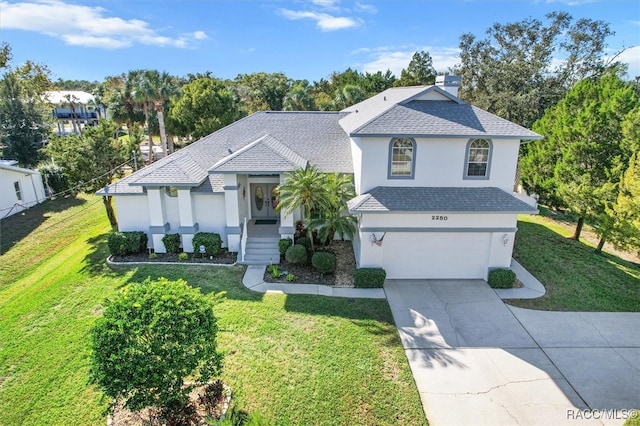 view of front facade with a front yard and a garage