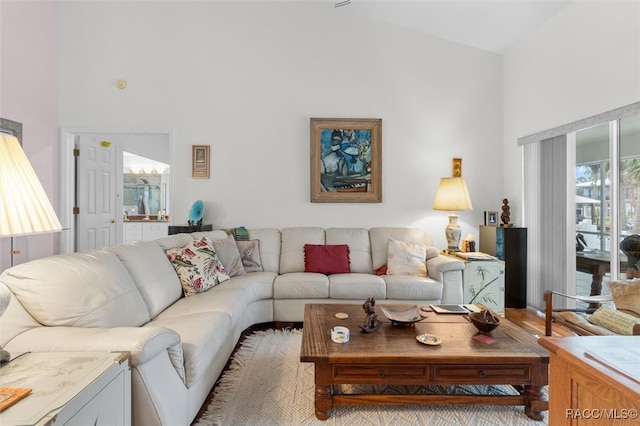 living room featuring high vaulted ceiling