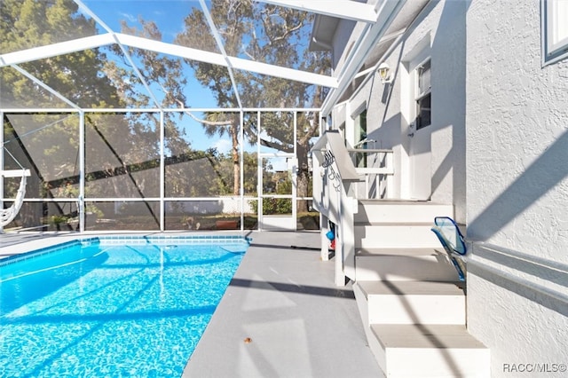 view of swimming pool with a lanai