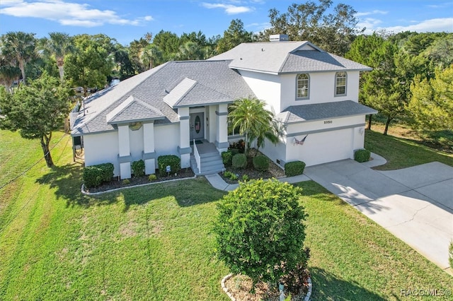 view of front facade featuring a front yard and a garage