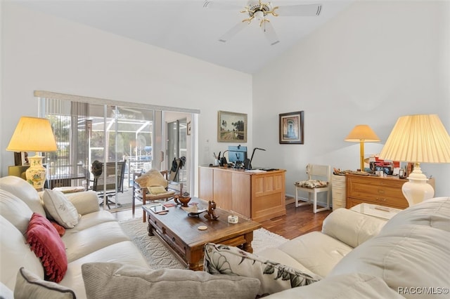 living room featuring ceiling fan, high vaulted ceiling, and wood-type flooring