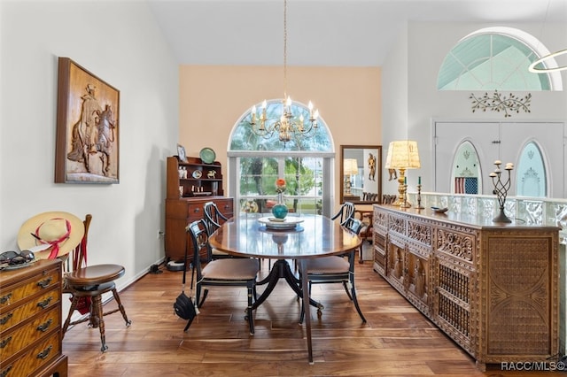 dining area with hardwood / wood-style floors and a notable chandelier