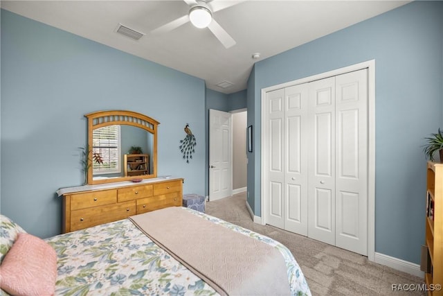 carpeted bedroom featuring visible vents, baseboards, a ceiling fan, and a closet