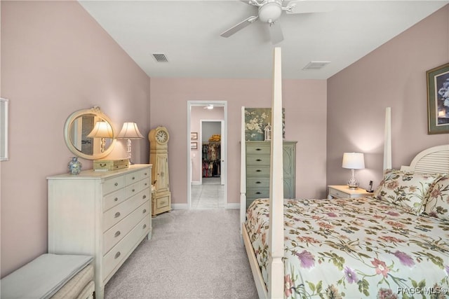 bedroom featuring light carpet, visible vents, baseboards, and a ceiling fan