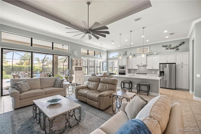 living area featuring recessed lighting, light tile patterned floors, a ceiling fan, and ornamental molding