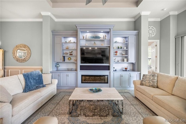 living room featuring crown molding and wainscoting