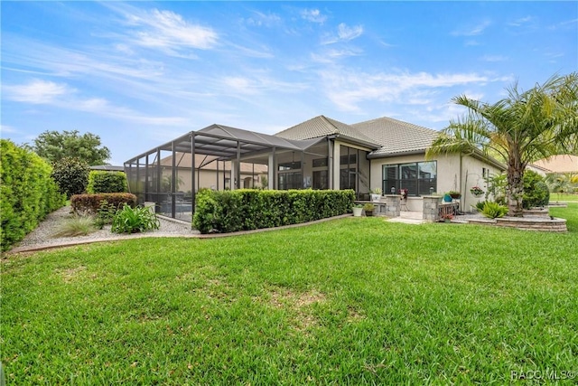 rear view of property featuring a yard, stucco siding, a tiled roof, and a lanai
