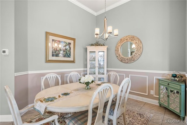 dining room with a notable chandelier, marble finish floor, and ornamental molding