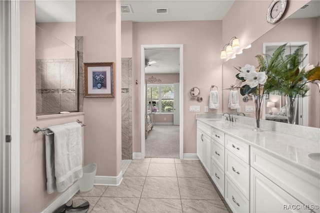 full bathroom featuring visible vents, walk in shower, baseboards, a sink, and double vanity