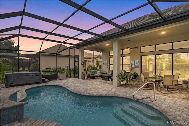 pool with a patio, an outdoor hangout area, a lanai, a hot tub, and ceiling fan