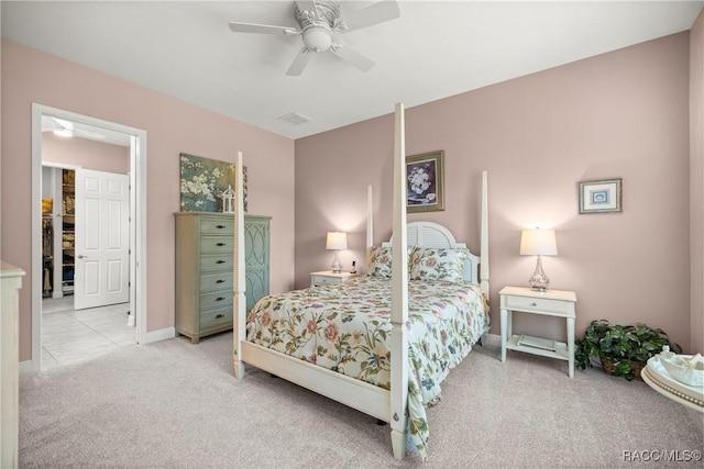 carpeted bedroom with visible vents, baseboards, and a ceiling fan