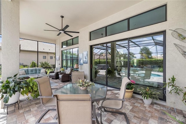 sunroom / solarium featuring an outdoor living space and a ceiling fan