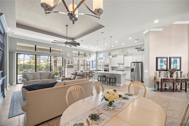 dining area featuring crown molding, light tile patterned floors, a towering ceiling, recessed lighting, and baseboards