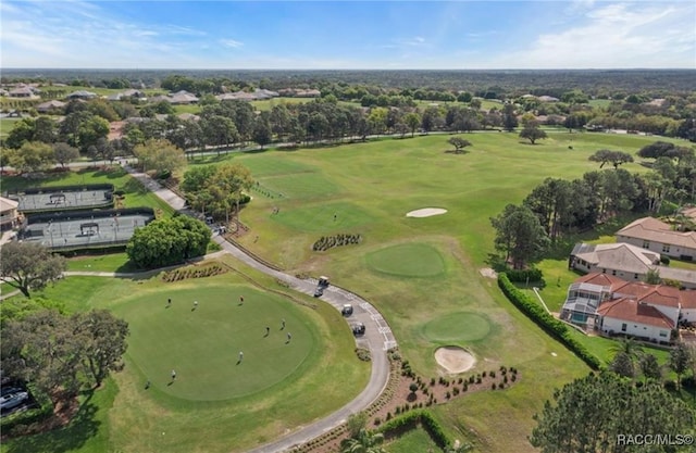 birds eye view of property with golf course view and a residential view