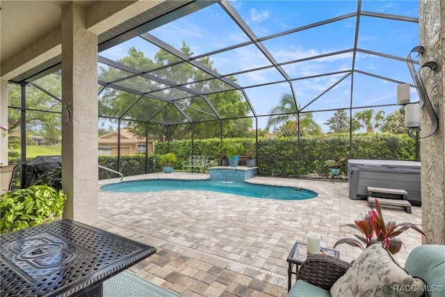 pool with glass enclosure, a patio, and a hot tub
