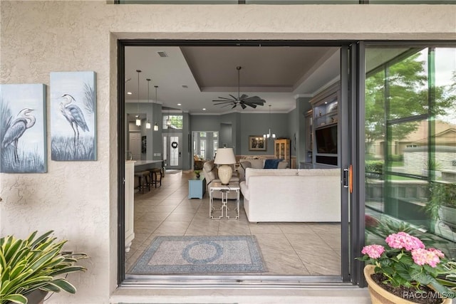 exterior space featuring visible vents, ceiling fan, and stucco siding